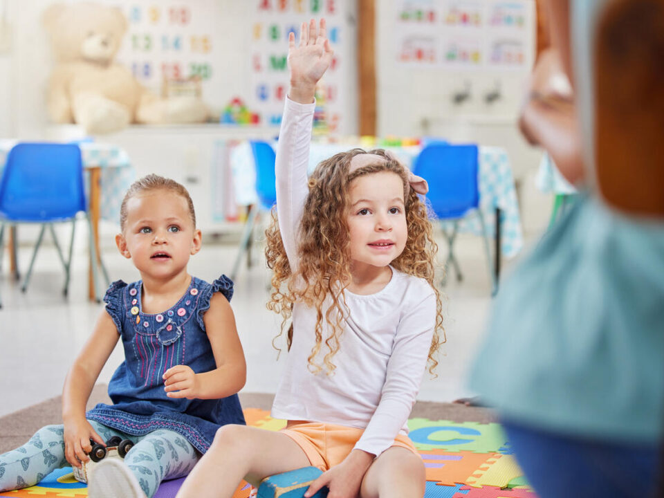 Shot of a little girl raising her hand in class