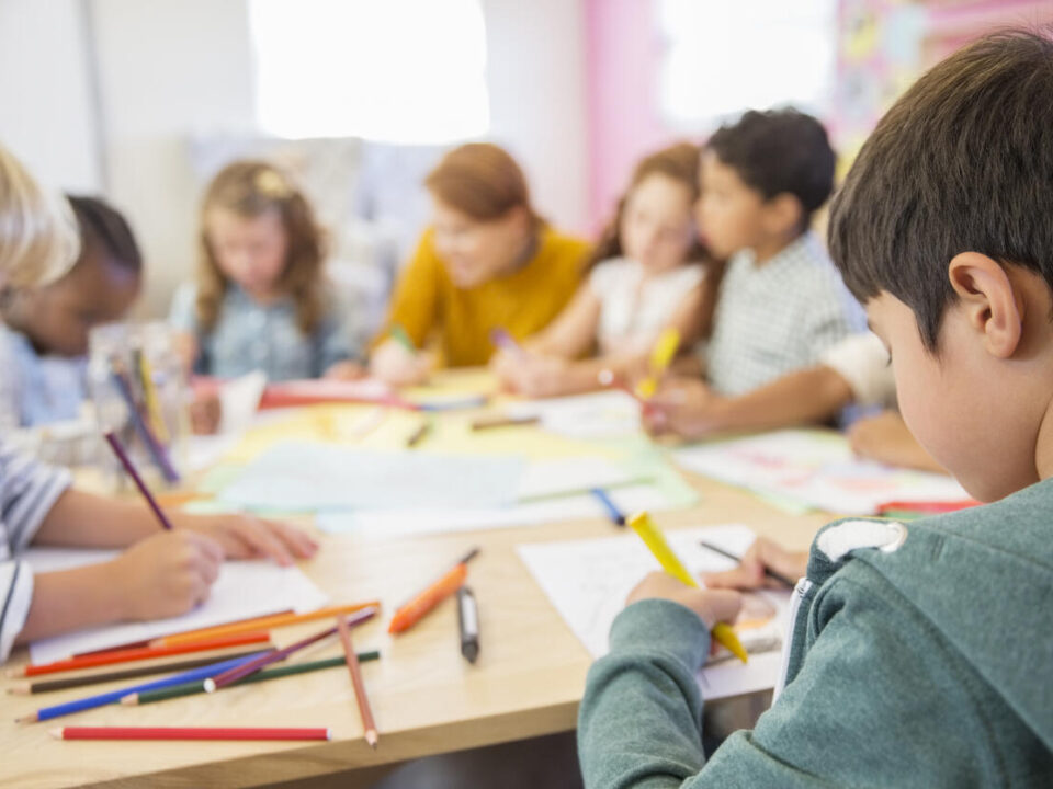 Teacher and students drawing in classroom